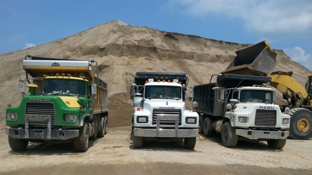 Fleet of trucks on job site